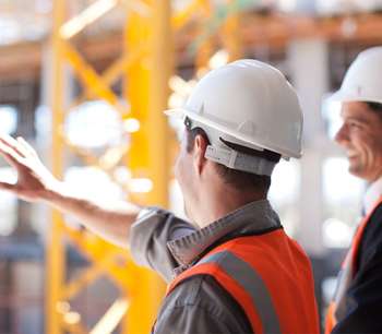 Men in hard hats talking on construction site