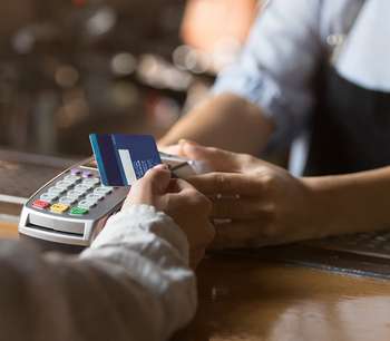 A customer pays via eftpos card at a bar