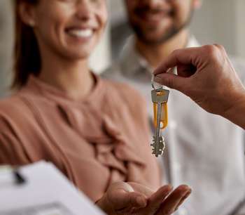 A young couple receive house keys