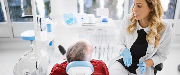 A dentist talks to her patient