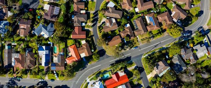 Aerial view of houses and streets in a Sydney suburb.