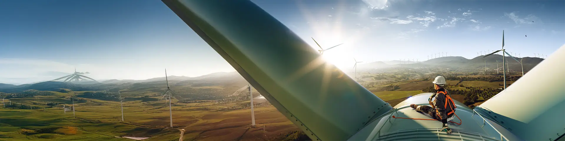 Engineer sits on top of wind turbine