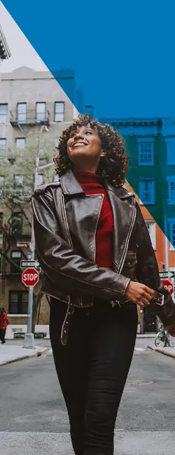 Decorative image of person smiling on the street.