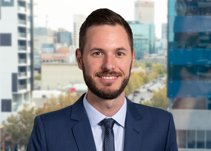 A photo of Anders Magnusson looking straight ahead with a view of Adelaide in the background