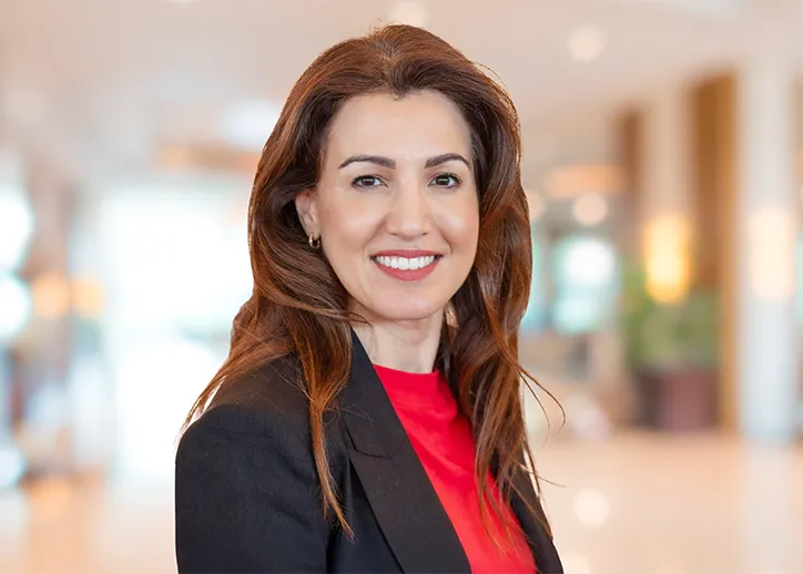 Nicole Aman, Chief Client Officer, smiling at the camera. 