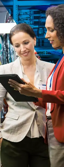 Decorative image of two people working in a server room.