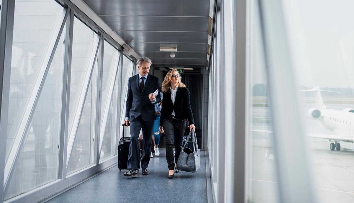 Decorative image of business people at airport.