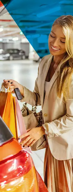 Decorative image of a person smiling in a carpark.