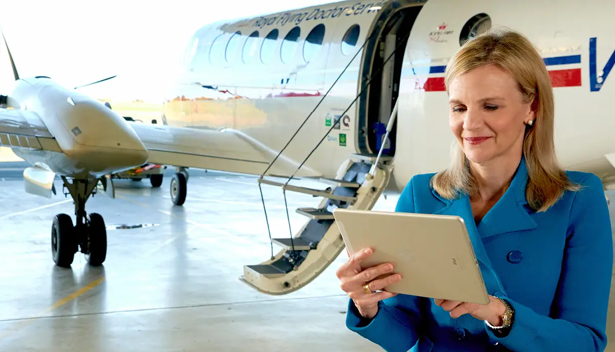 Photo of Meredith Staib, CEO, Royal Flying Doctor Service, looks at a tablet