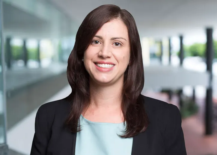 A photo of Ann Stratikopoulos looking straight ahead with a view of BDO Cairns in the background