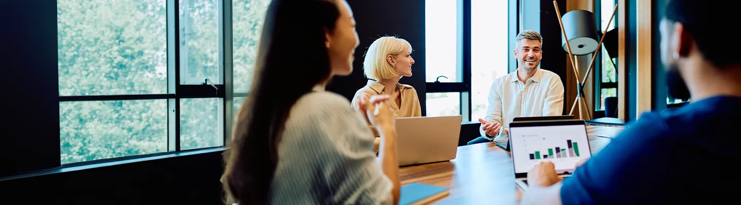 Team of professionals having a discussion in a bright modern office.