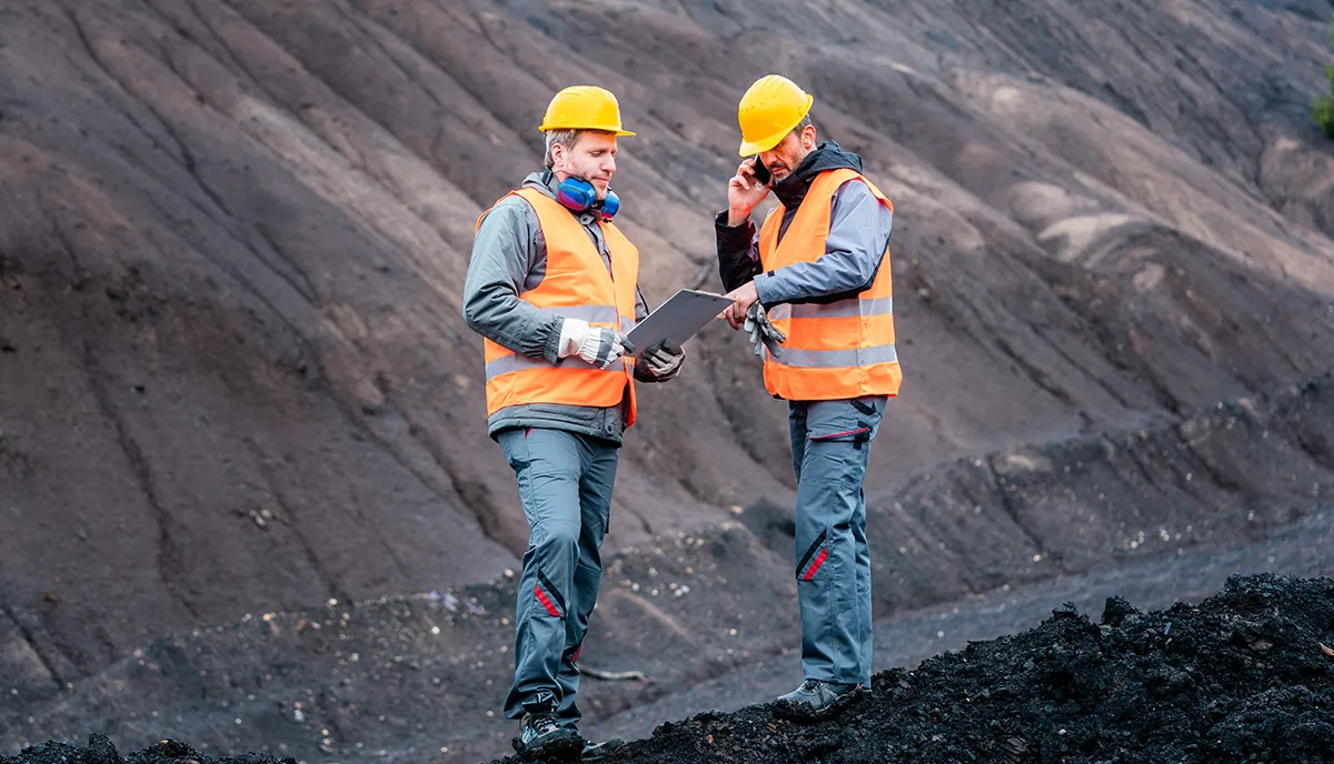 Workers in open-cast mining operation pit