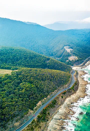 Cars driving on Great Ocean Road, Victoria, Australia.