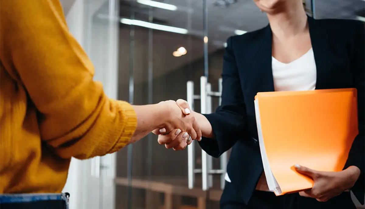 two people shake hands