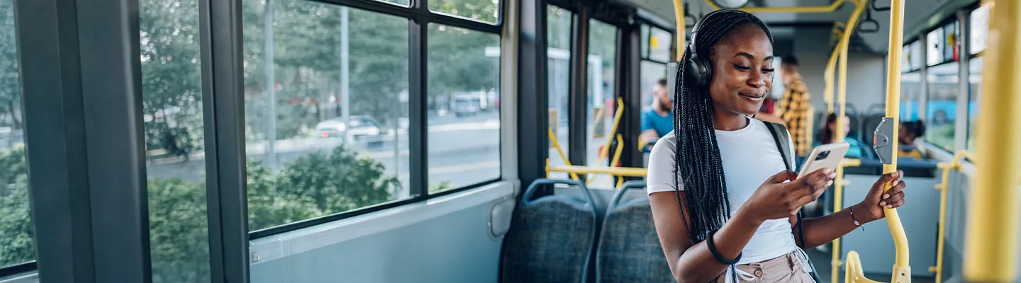 Lady standing up on a bus