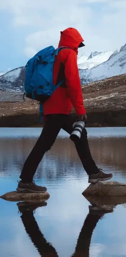 Decorative photo of a person walking through snowfield